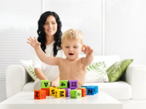 Little boy with blocks parental role model