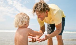 happy father son beach blonde parenting slider